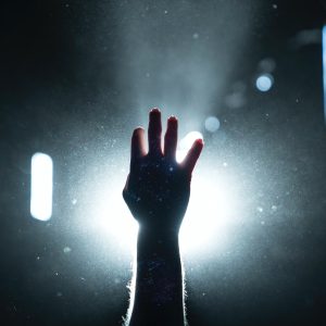 Person's hand on light